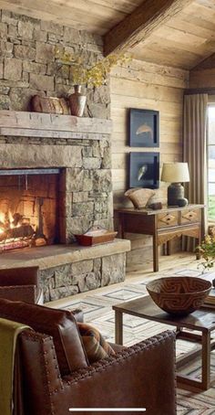 a living room filled with furniture and a fire place in the middle of a room