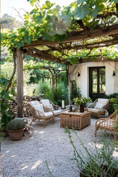 an outdoor patio with wicker furniture and potted plants