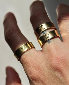 My best selling Sun, Moon, & Star rings are now available in brass gold! These rings are more solid than my silver aluminum ones, so they won't adjust as easily. Size ranges from about 6-10. Ring may turn color over time if exposed to too much water, sweat etc.  The black ink is not permanent & will come off over time, however you can fill it in with a black sharpie or marker & wipe it off. It'll be good as new! Each ring is hand stamped by me & made to order!! These are the perfect personalized gift :) choose either sun, moon, or star in the drop down menu! Each ring sold separately. Celestial Everyday Adjustable Rings, Adjustable Celestial Rings For Everyday Wear, Everyday Adjustable Celestial Rings, Adjustable Celestial Midi Rings, Adjustable Moon Shaped Celestial Midi Rings, Adjustable Moon-shaped Celestial Midi Rings, Adjustable Celestial Moon Midi Rings, Adjustable Gold Star-shaped Rings, Adjustable Gold Star Ring