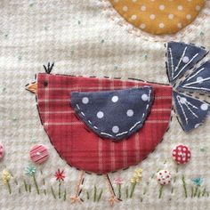 a patchwork bird with polka dots on it