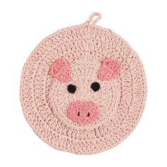 a crocheted pig rug with black eyes and pink cheeks is shown on a white background