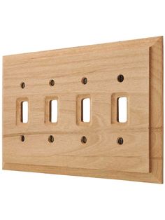 a light switch cover with four holes in the middle and two on each side, made out of wood