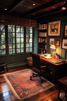 a home office with wood floors and green walls, along with a rug on the floor