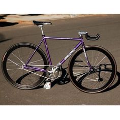 a purple bike is parked on the street