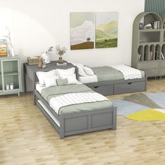 two beds in a room with wooden floors and white walls, one is gray and the other is light green