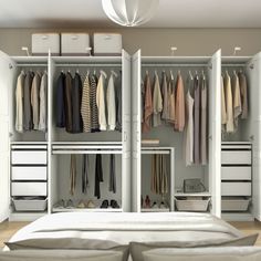 an organized bedroom closet with clothes and shoes on the shelves, drawers, and bed