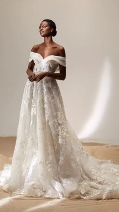 a woman in an off the shoulder wedding dress