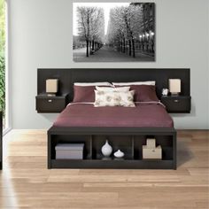 a bedroom with a bed, nightstands and pictures on the wall above it in black and white