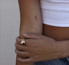 a close up of a person's arm with a ring on it