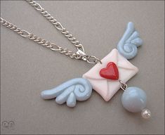 a necklace with an envelope and heart on it