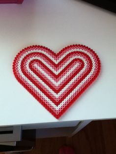 a heart shaped object sitting on top of a table