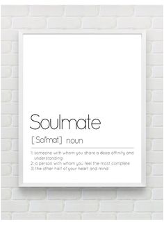 a white poster with the words soulmate on it in black and white, against a brick wall