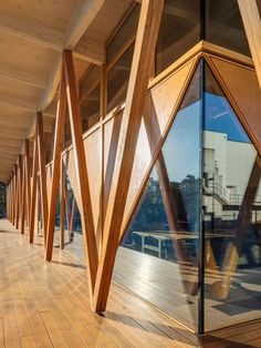 a wooden building with glass walls and wood flooring