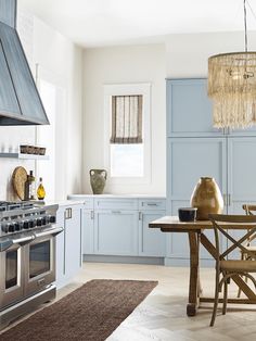 a kitchen with blue cabinets and an oven