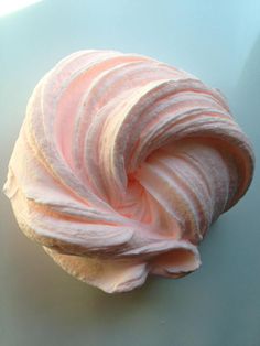 a cupcake with pink frosting on it sitting on top of a blue plate