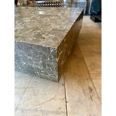 a marble table top sitting on top of a hard wood floor