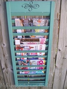 an old fashioned vending machine in front of a wooden fence