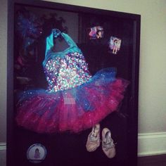 there is a display case with shoes and a bag on it, in the shape of a ballerina's tutu skirt