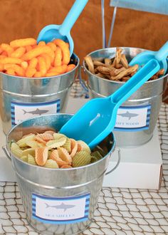 three buckets filled with food on top of a white tablecloth covered floor next to each other