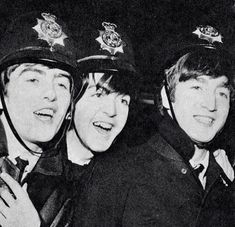 three young men in police uniforms posing for the camera