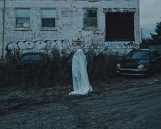 a ghost standing in front of an abandoned building