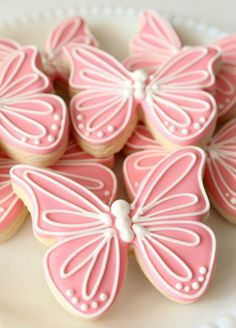 pink butterfly cookies on a white plate