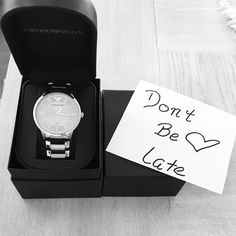 a watch in a box with a note attached to it that says don't be late