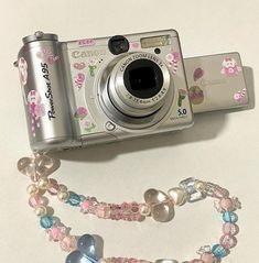 a camera and some beads on a table