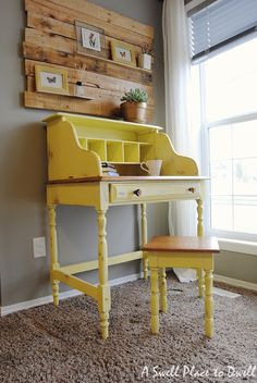 a yellow desk in front of a window with a potted plant on top of it