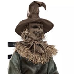 a scarecrow with a hat and tie on it's head, standing in front of a white background