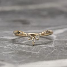 a yellow gold ring with three small diamonds