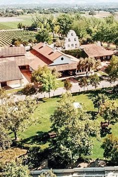 an aerial view of a farm with trees and buildings