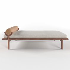 a wooden bench with a cushion on it and a roll of paper in the middle