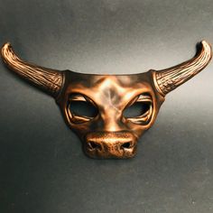 Experience the essence of strength and magnificence with our captivating bull mask adorned with striking copper bull horns. Step into the world of these majestic creatures, exuding their fearless spirit and commanding presence. This mask is the perfect addition to any masquerade outfit or Halloween costume! Age Group/Gender - Adult/Men Size/Type - One size fits all adults Mask Color - Copper Mask Material - Polyresin Bull Masquerade Mask, Animal Masquerade Mask, Animal Masquerade, Bull Mask, Bull Animal, Masquerade Outfit, Mens Masquerade Mask, Mask Collection, Mask For Men