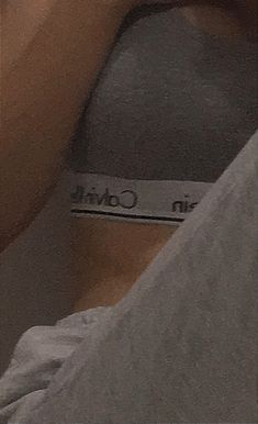 a person laying in bed holding a cell phone to their ear with the words in control written on it