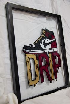 an image of a shoe with drip painted on it in a black and white frame