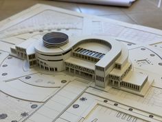 a model of a building on top of blueprints