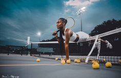 a woman is playing tennis on the court with balls around her and racket in hand