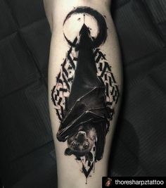 a tattoo on the leg of a person with a bat