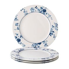 four blue and white plates stacked on top of each other in front of a white background