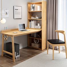 a wooden desk with a laptop on top of it next to a chair and bookcase