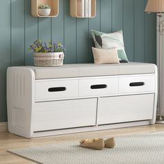 a white bench with storage drawers underneath it