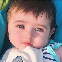 a close up of a baby in a car seat