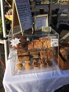 an assortment of pastries on display at a market