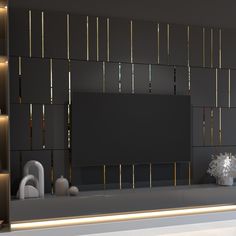 a modern living room with black walls and gold trimmings on the back wall