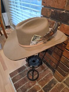 Custom Cattleman cowboy hat in 100% Australian wool. Classic cattleman crown shape with a straight crease down the middle. Brim is slightly upturned on the sides. Burned for a distressed look.   Stiff, structured material Crown size: 57 cm. Roomy fit. Adjustable sizing, hook-and-loop tab inside sweatband Brim: 4 in. Crown height: 4.5 in. One Size- One Size Shipping Get it within 3- 5 business days. Ships from United States Southern Style Brown Hat Band For Rodeo, Rustic Flat Brim Hat For Rodeo, Southern Style Brown Hat Bands For Rodeo, Country Style Hat With Flat Crown For Country Events, Rustic Top Hat With Flat Brim For Country Events, Fitted Brimmed Rustic Fedora, Southern Style Fedora For Western-themed Events, Fitted Rustic Hat For Country Events, Rustic Curved Brim Hunting Hat