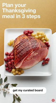 a white plate topped with meat and beans next to a fork on top of a table