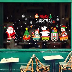 a christmas window with santa clause and snowmen on the windowsill, in front of a restaurant