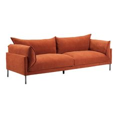 an orange couch sitting on top of a white floor