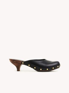 Chlo�é Judith Clog | Chloé US Luxury Leather Clogs With Wooden Heel, Luxury Clogs With Leather Sole And Open Heel, Luxury Leather Sole Clogs With Open Heel, Luxury Clogs With Wooden Open Heel, Luxury High Heel Clogs With Leather Sole, Chic Clogs With Wooden Low Heel, Elegant Clogs With Wooden Heel For Workwear, Luxury Mules With Wooden Heel And Round Toe, Elegant Clogs With Wooden Heel And Almond Toe